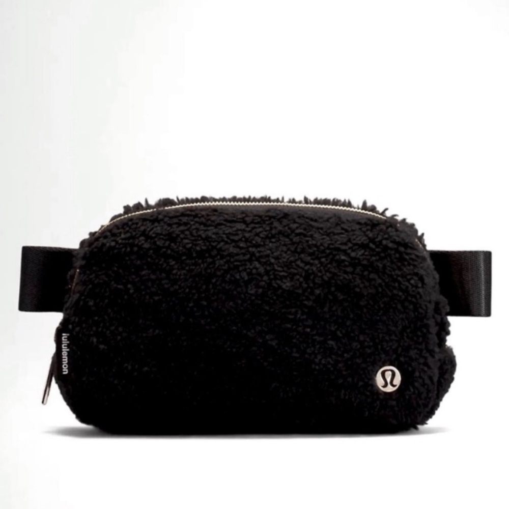 Elegant plush black lululemon everywhere belt bag with gold detail.